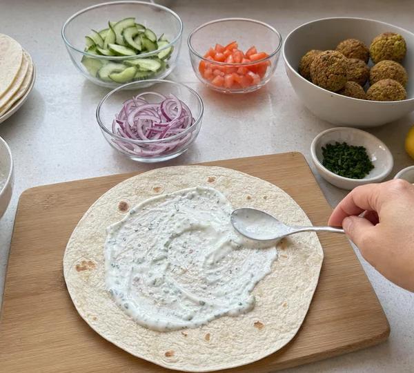 Step 5: Spread tzatziki sauce