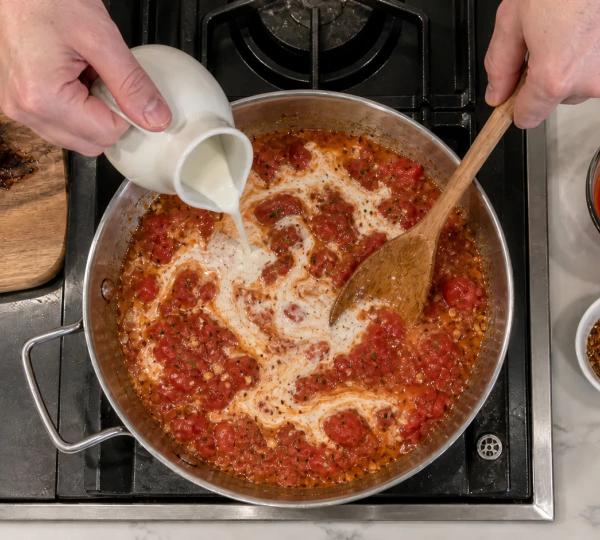 Step 7: Stir in crushed tomatoes