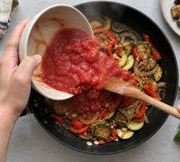 Step 6: Pour in the canned tomatoes
