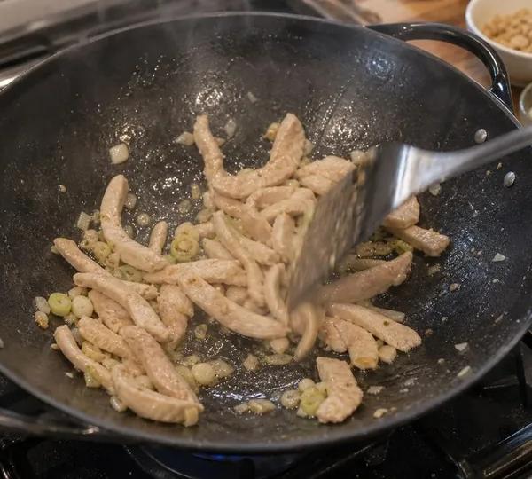 Step 13: Add chicken and stir-fry
