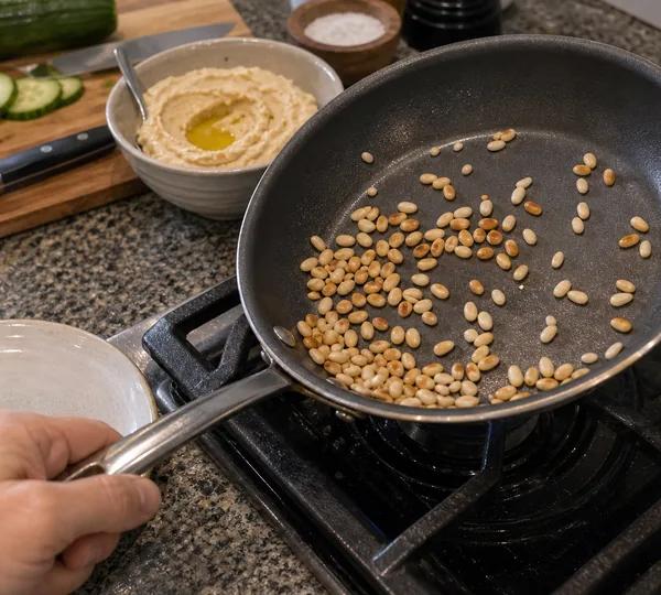 Step 2: Add the pine nuts