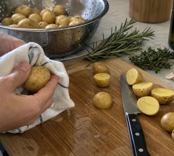 Step 2: Wash potatoes and halve any