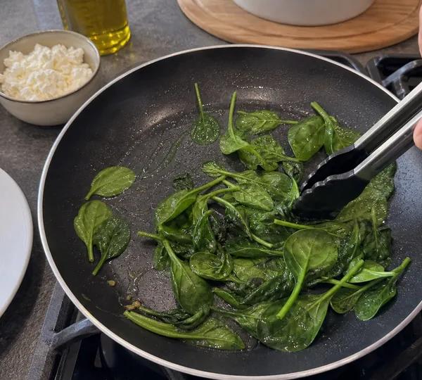 Step 2: Add the spinach and toss